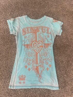 Woman’s Sinful Tee gold cross
